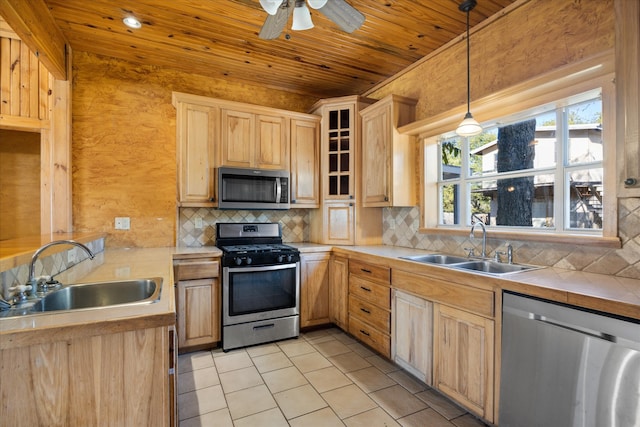 kitchen featuring decorative backsplash, wooden ceiling, sink, pendant lighting, and stainless steel appliances