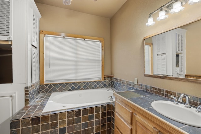 bathroom with vanity and tiled tub