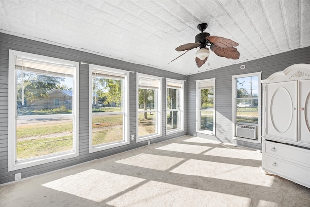 unfurnished sunroom with cooling unit, a healthy amount of sunlight, and ceiling fan