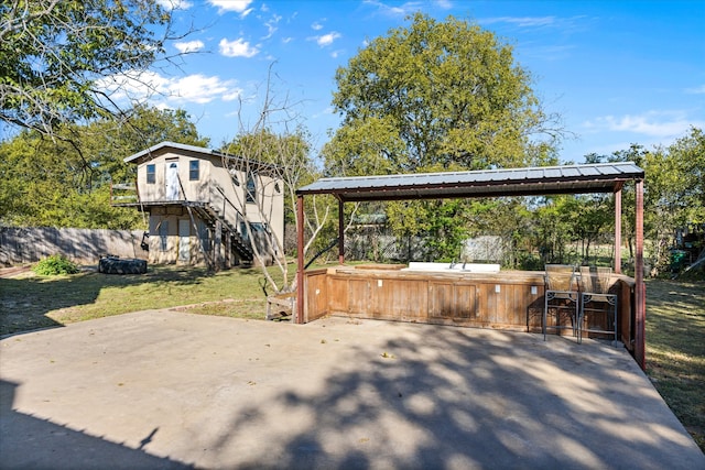 view of patio / terrace with a hot tub