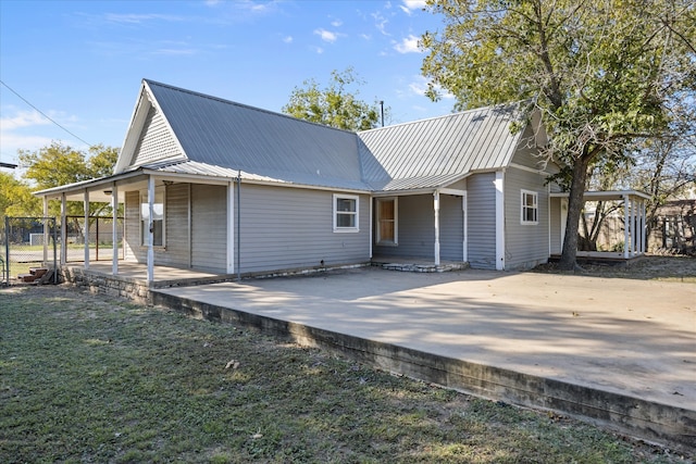 back of house with a patio and a yard