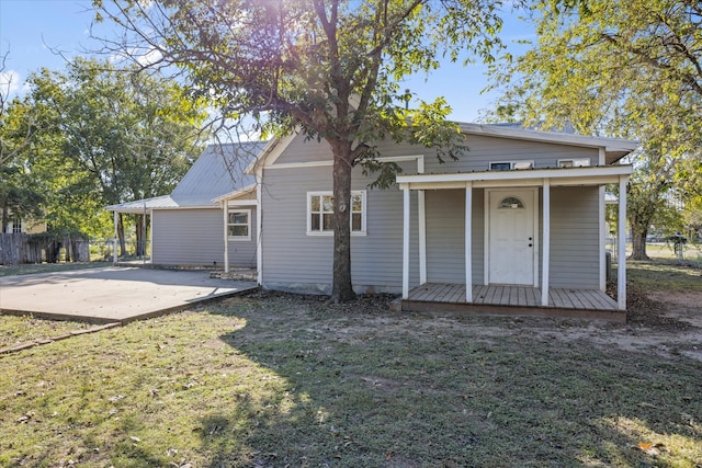 back of property featuring a lawn