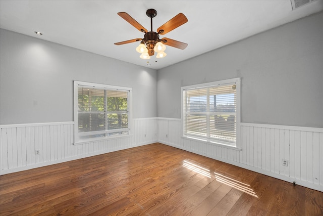 spare room featuring hardwood / wood-style floors and ceiling fan