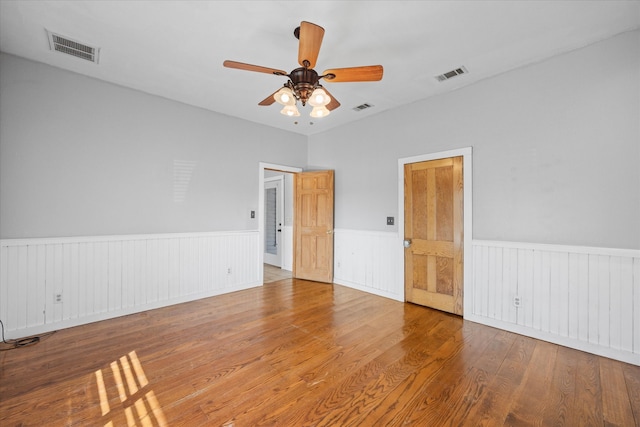 spare room with hardwood / wood-style flooring and ceiling fan