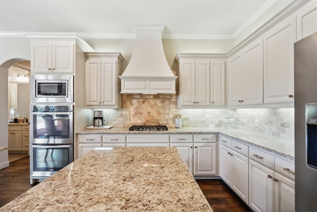 kitchen with white cabinets, custom range hood, dark hardwood / wood-style flooring, and stainless steel appliances