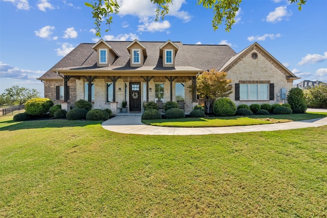 view of front of property with covered porch and a front lawn