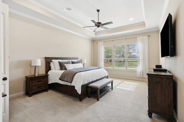 carpeted bedroom featuring a raised ceiling, ceiling fan, and ornamental molding