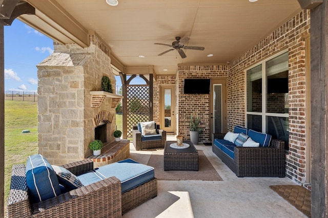 view of patio featuring an outdoor living space with a fireplace and ceiling fan