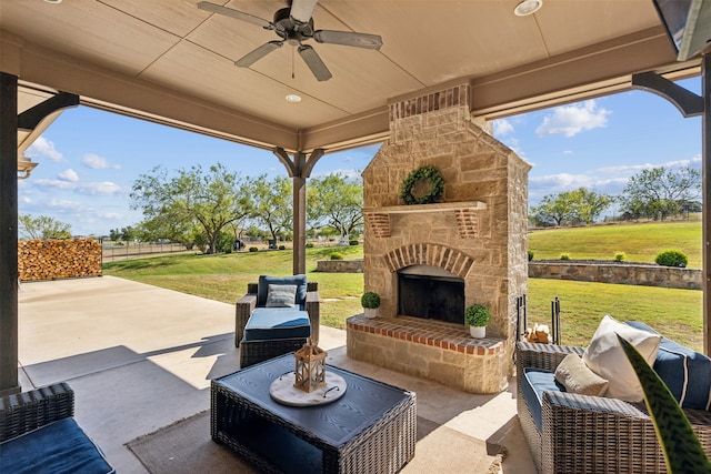 view of patio / terrace featuring an outdoor stone fireplace and ceiling fan