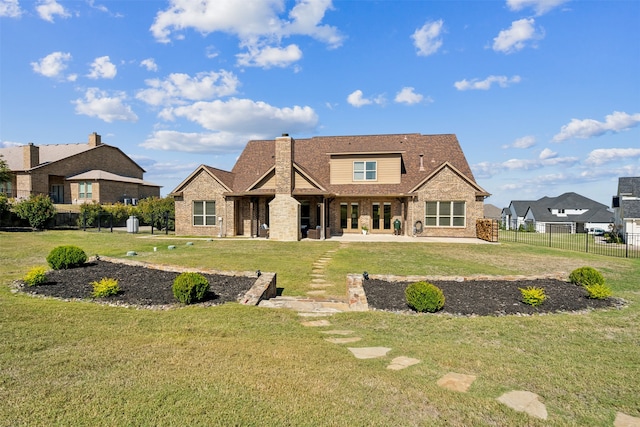 rear view of house with a yard