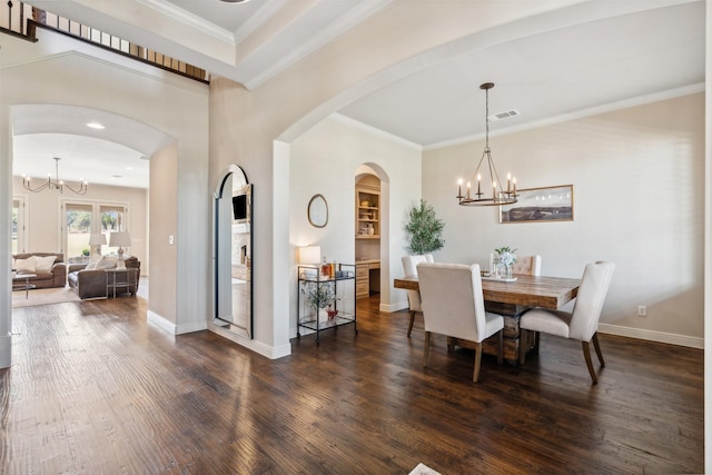 dining space featuring crown molding, dark hardwood / wood-style floors, and a notable chandelier