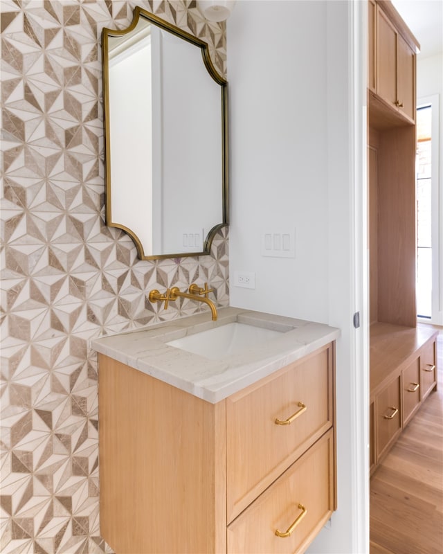 bathroom featuring vanity and decorative backsplash