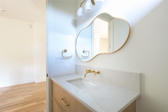 bathroom featuring hardwood / wood-style floors and vanity