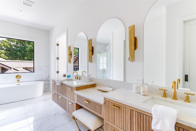 bathroom with a wealth of natural light, marble finish floor, a shower with shower door, and a sink