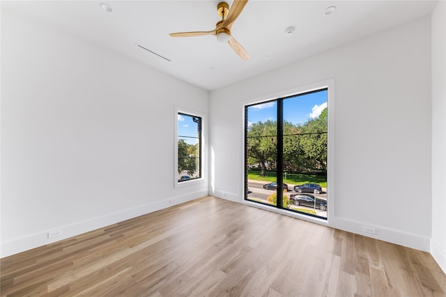 empty room featuring ceiling fan and light hardwood / wood-style floors