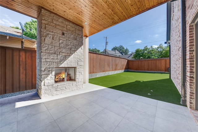 view of patio / terrace with an outdoor stone fireplace