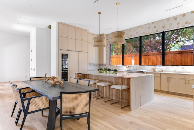 kitchen with a center island, a wealth of natural light, and light hardwood / wood-style flooring