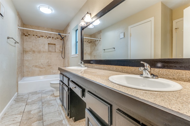 full bathroom featuring tile patterned floors, vanity, tiled shower / bath combo, and toilet