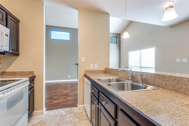 kitchen featuring light wood-type flooring, white appliances, dark brown cabinetry, sink, and pendant lighting