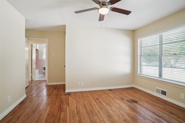 unfurnished room with hardwood / wood-style floors and ceiling fan