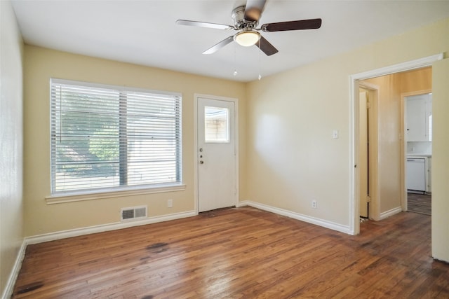 interior space with ceiling fan, plenty of natural light, and dark hardwood / wood-style floors