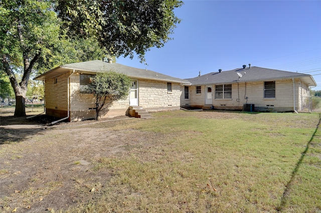 back of property with cooling unit and a yard