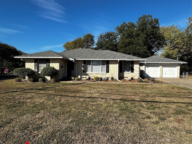 single story home with a garage and a front lawn