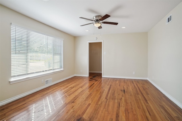 unfurnished room with ceiling fan and light wood-type flooring