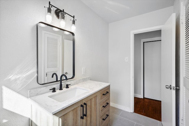 bathroom with tile patterned flooring and vanity