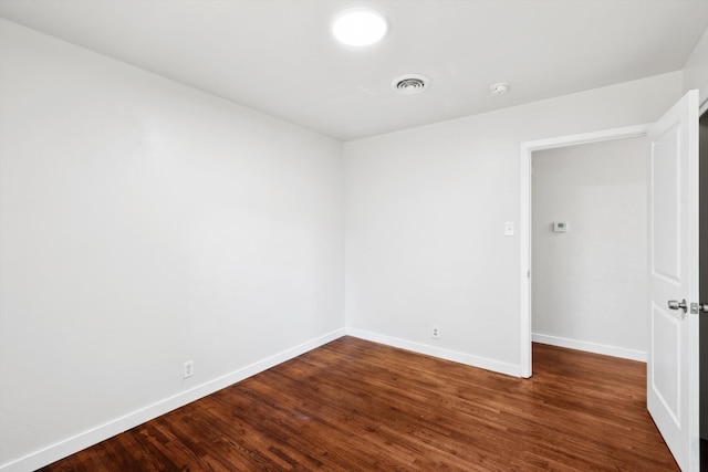 empty room with dark wood-type flooring