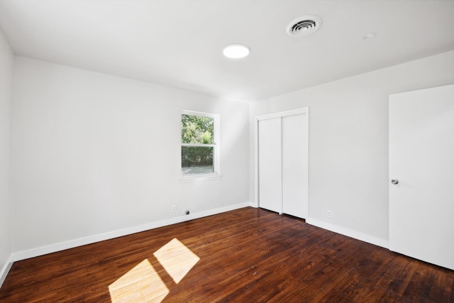 empty room with dark wood-type flooring