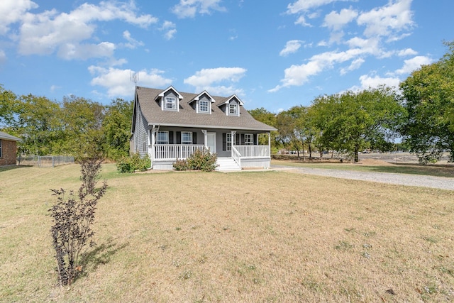 cape cod house with covered porch and a front lawn