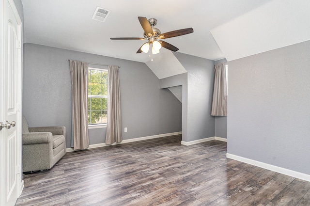 bonus room featuring visible vents, vaulted ceiling, baseboards, and wood finished floors