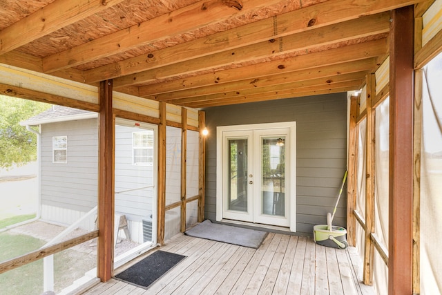 unfurnished sunroom with french doors