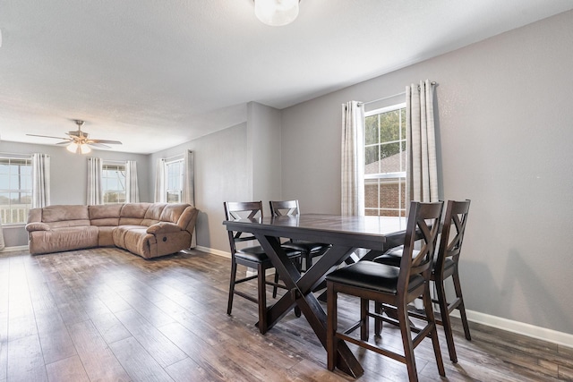 dining area featuring a ceiling fan, plenty of natural light, baseboards, and wood finished floors