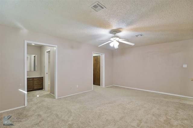 carpeted empty room with a textured ceiling and ceiling fan