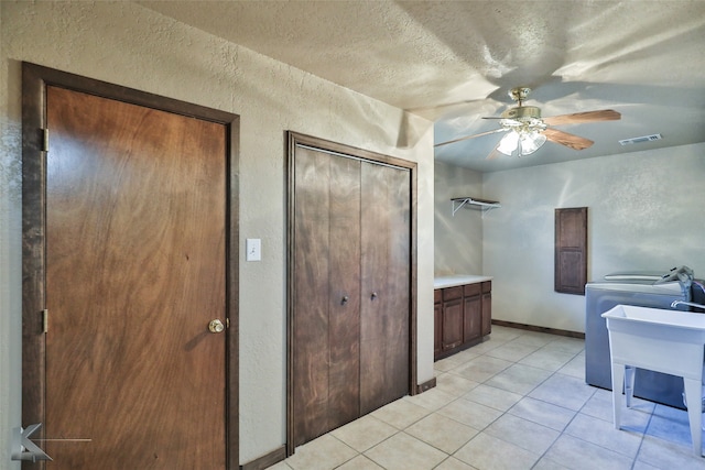 bathroom featuring a textured ceiling, tile patterned flooring, sink, and ceiling fan