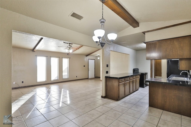 kitchen with vaulted ceiling with beams, hanging light fixtures, sink, light tile patterned floors, and ceiling fan with notable chandelier