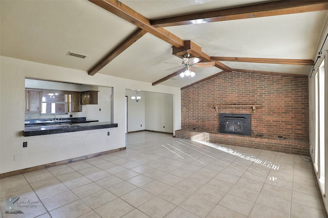 unfurnished living room with light tile patterned floors, ceiling fan, vaulted ceiling with beams, sink, and brick wall