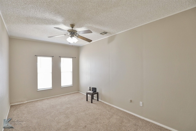 spare room with light carpet, a textured ceiling, and ceiling fan