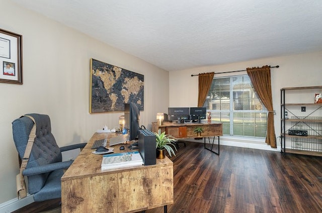 office area featuring dark wood-type flooring and a textured ceiling