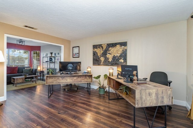 home office featuring wood-type flooring and a textured ceiling