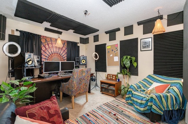 carpeted home office with a textured ceiling