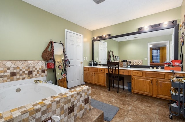 bathroom with a tub to relax in and vanity