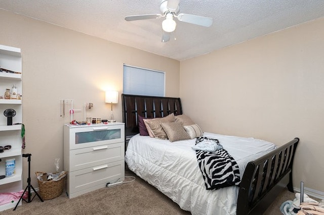 bedroom with a textured ceiling, carpet flooring, and ceiling fan