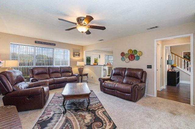 living room with carpet, a wealth of natural light, and ceiling fan