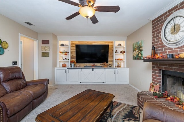 living room with a fireplace, built in features, light carpet, and ceiling fan