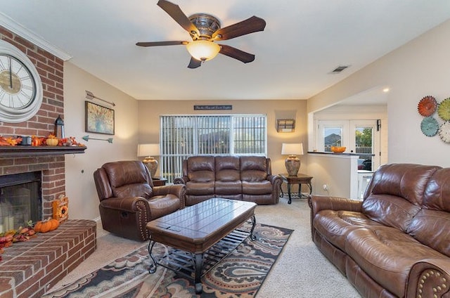 living room featuring a brick fireplace, french doors, light colored carpet, and ceiling fan