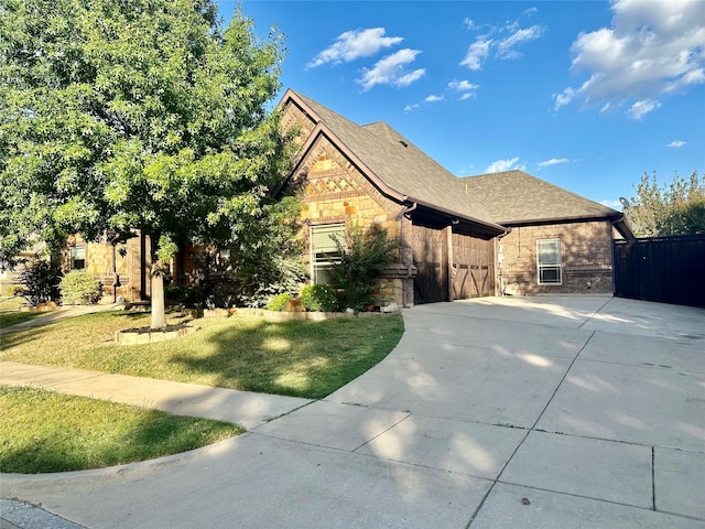 view of side of home with a yard