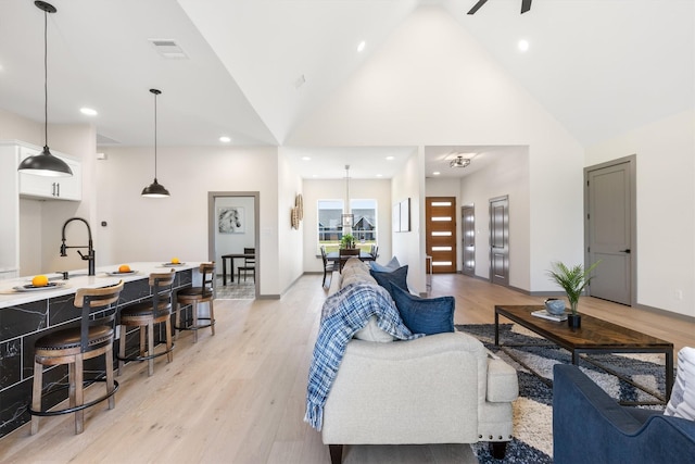 1561 Dixie Estates Way, Whitesboro, TX 76273 - living area featuring light wood finished floors, high vaulted ceiling, recessed lighting, baseboards, and ceiling fan